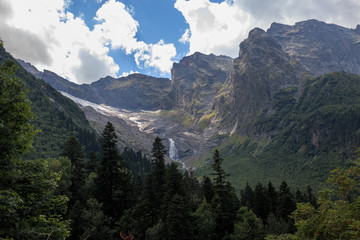 Panorama view on mountains scene and away waterfall in national park of Dombay