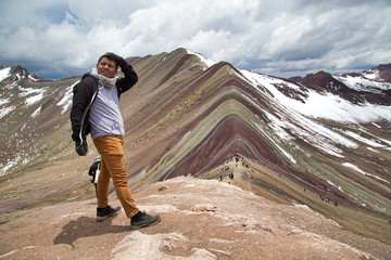 Man with panoramic view. Hiking scene in Vinicunca, Cusco region, Peru. Montana of Seven Colors, Rainbow Mountain
