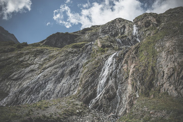 Fototapeta na wymiar Panorama view of waterfall scene in mountains, national park of Dombay, Caucasus