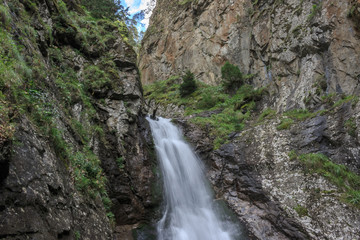 Closeup view of waterfall scenes in mountains, national park Dombay, Caucasus
