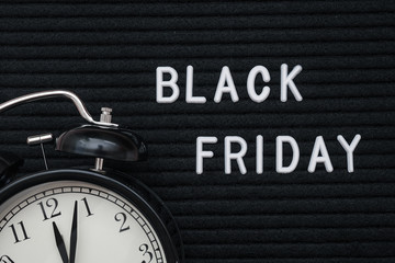 White text Black friday on black letter board and alarm clock , closeup. Concept Black friday , season sales time. Flat lay Top view Copy space Template layout for your design