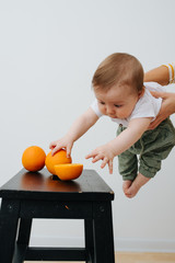 Image of Little boy grabbing juicy fruits