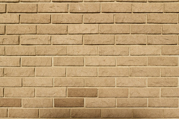Tan color natural stone brick wall background with rounded rough texture blocks