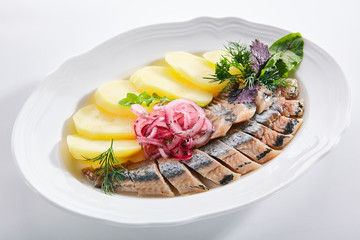 Raw Salted Soused Herring with Onions and Potato Isolated
