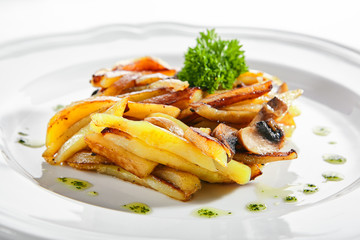 Fried Potatoes with Mushrooms on a Restaurant Plate Isolated