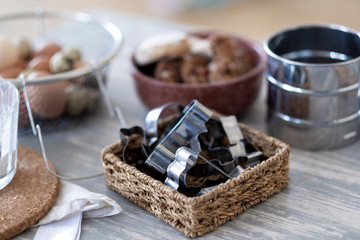 Metal cookie cutters and products lying on an old wooden table