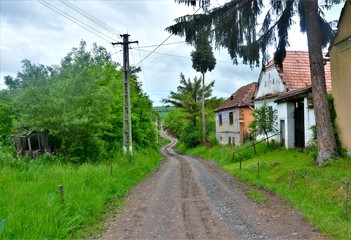 Fototapeta na wymiar a dirt road through a village in Romania