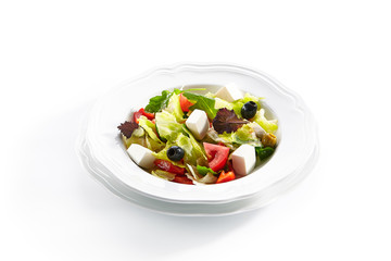 Macro Shot of Greek Salad in Light Plate Isolated on White Background