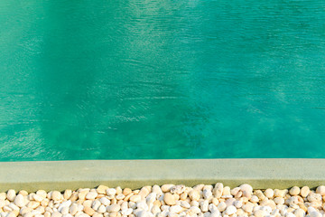 Stone border in front of swimming pool