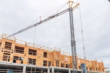 Building under construction. The site with crane.