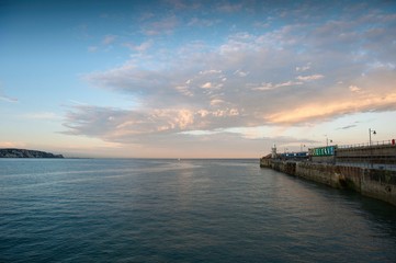 Fototapeta na wymiar Folkestone Harbour Arm with Dover in the distance