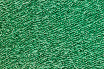 Texture of green towel fur. Concept of clothes or fashion.