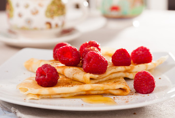 delicious  pancakes with fresh raspberries and honey