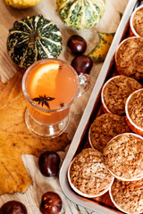 Pumpkin and carrot cupcakes and orange autumn drink. Healthy autumn pastries. Cafe concept, menu.