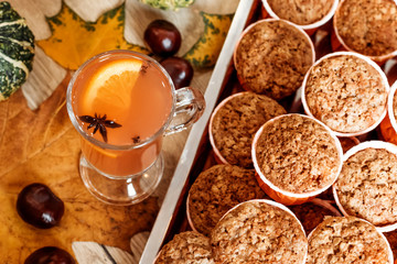 Pumpkin and carrot cupcakes and orange autumn drink. Healthy autumn pastries. Cafe concept, menu.