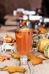 Orange autumn drink with spices in the cafe.