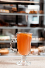 Orange autumn drink with spices in the cafe.