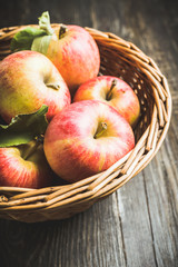 Freshly harvested ripe apple on the rustic wooden background. Selective focus. Shallow depth of field.