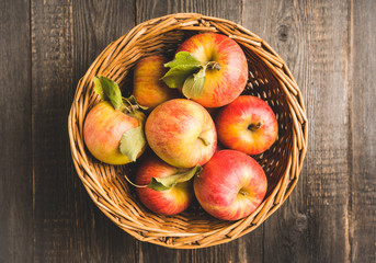 Freshly harvested ripe apple on the rustic wooden background. Selective focus. Shallow depth of field.
