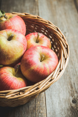 Freshly harvested ripe apple on the rustic wooden background. Selective focus. Shallow depth of field.