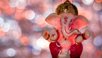 Ganesha statue with beutiful lights in the background for Ganpati pooja concept