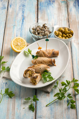 sword fish rolled up with capers and green olives