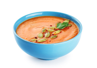 Pumpkin cream soup with seeds isolated on white background.