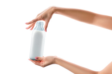Female hands with almond milk bottle isolated on white