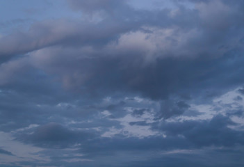 Fototapeta premium Dark blue beautiful sky with high fluffy clouds in twilight