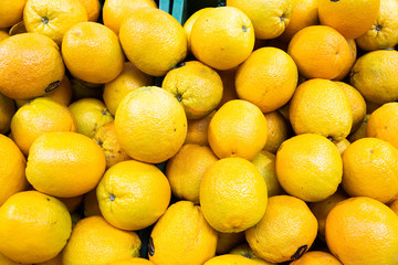 exotic yellow fruit oranges at farmer's market or grocery store aerial view. May be used for background. Top view.