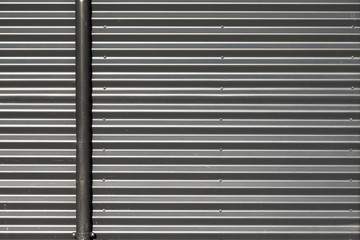 Corrugated metal wall with gas tube on the left