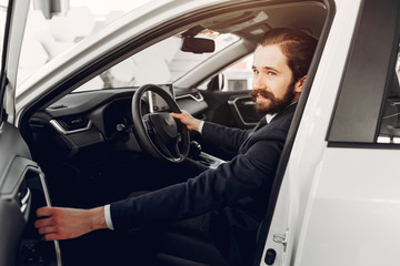 Man buying the car. Businessman in a car salon