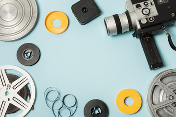 Film reel; film strips and camcorder on blue background with copy space for writing the text