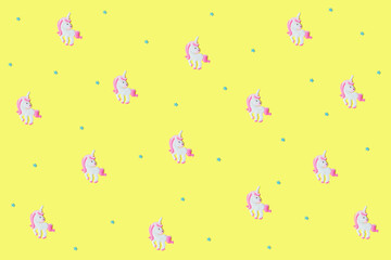 Blue stars and pink unicorns on yellow backdrop.