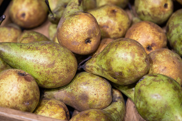 Closeup of fresh green pears on supermarket counter
