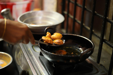 Woman Standing Her Kitchen Holding Spoon Preparing Snacks, fried onion bhajis