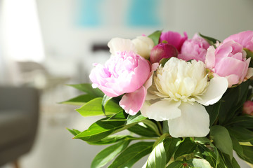 Bouquet of beautiful peonies in room, closeup. Space for text