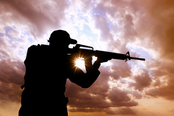 Soldier with machine gun patrolling outdoors. Military service