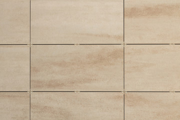 Textured pattern on beige rectangular tiles with dark space in between
