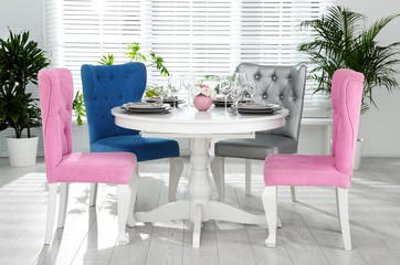 Elegant dining room interior with stylish chairs and table