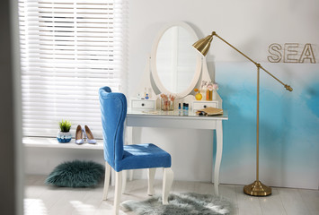 Fototapeta premium Elegant dressing table and blue chair in stylish room interior
