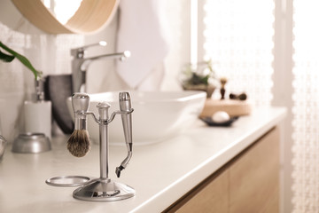 Shaving accessories on countertop in stylish bathroom