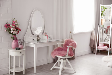 Stylish room interior with white dressing table
