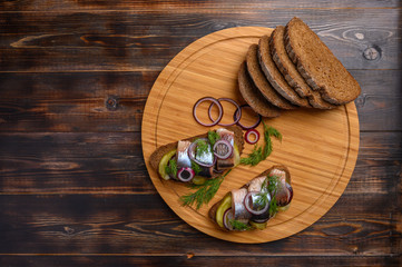 Nop view traditional Russian snack-sandwich with herring, bread and onions