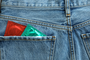 Closeup view of jeans with condoms in pocket. Safe sex concept