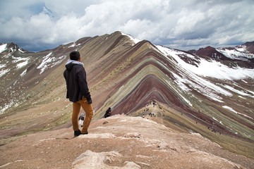 Man with panoramic view. Hiking scene in Vinicunca, Cusco region, Peru. Montana of Seven Colors, Rainbow Mountain