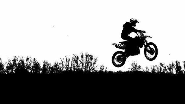 Silhouettes Bouncing on the trampoline motorcyclists on a white headlight.