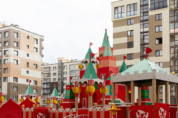 Bright colourful playground for children at apartment background in dormitory district