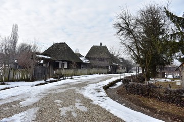Wooden house in winter landscape in Romania