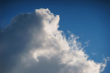 Large white cumulus clouds against a blue sky.